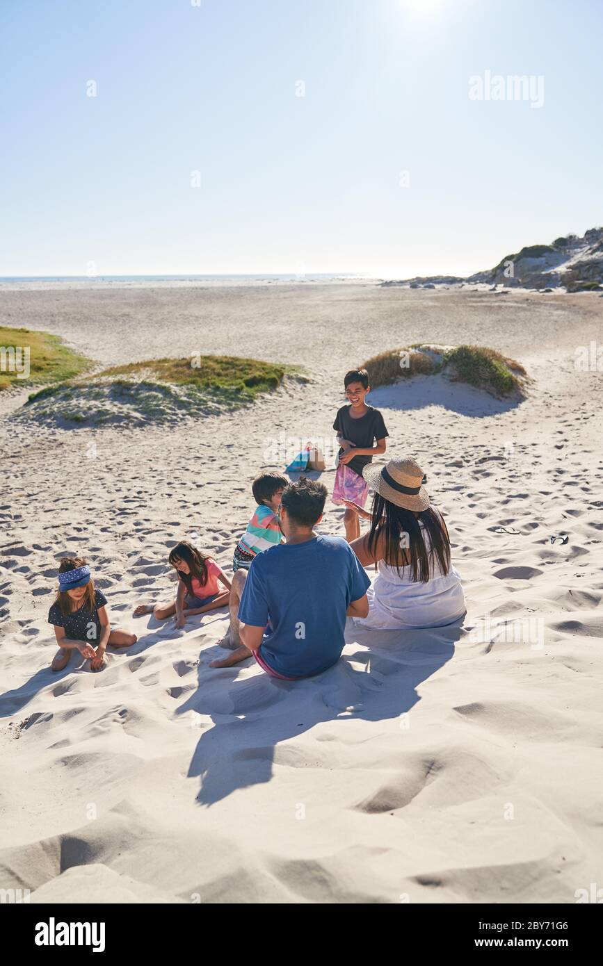 Family playing and relaxing on sunny beach, Cape Town, South Africa Stock Photo
