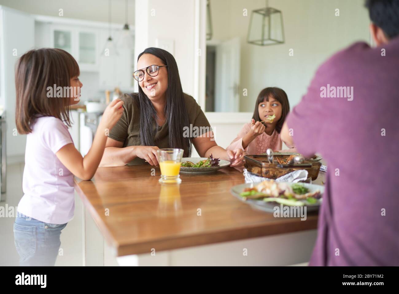 Happy family eating lunch at table Stock Photo