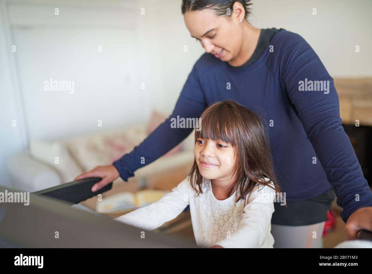 Mother and daughter on treadmill Stock Photo