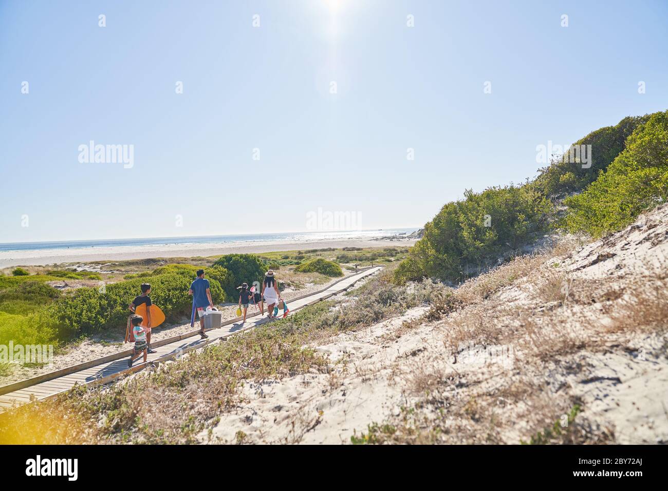Family walking on sunny beach path, Cape Town, South Africa Stock Photo