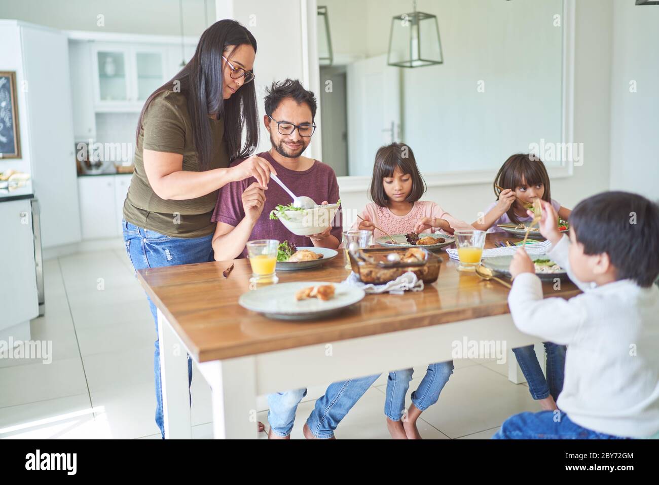 Family eating lunch at dining table Stock Photo