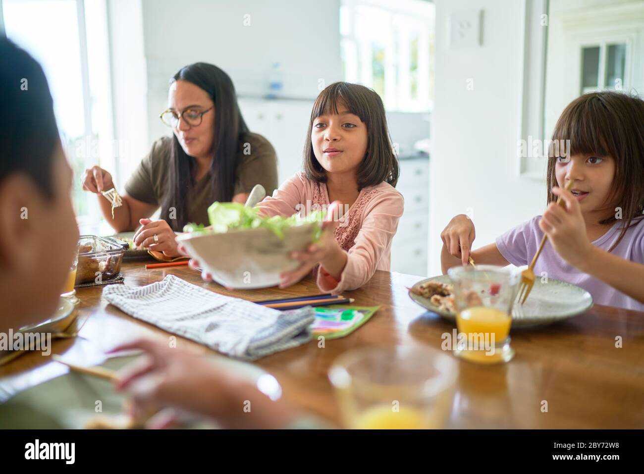 Family eating lunch at dining table Stock Photo