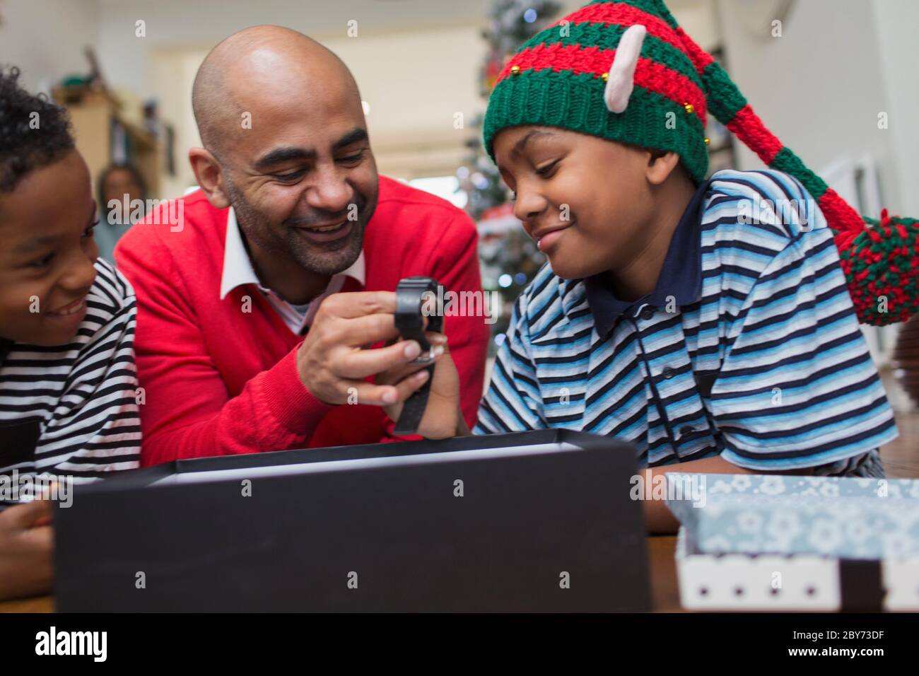 Father receiving wristwatch from sons for Christmas Stock Photo