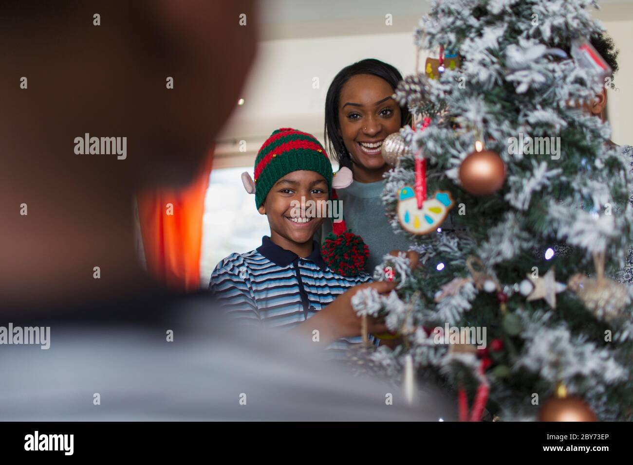 Portrait happy mother and son decorating Christmas tree Stock Photo