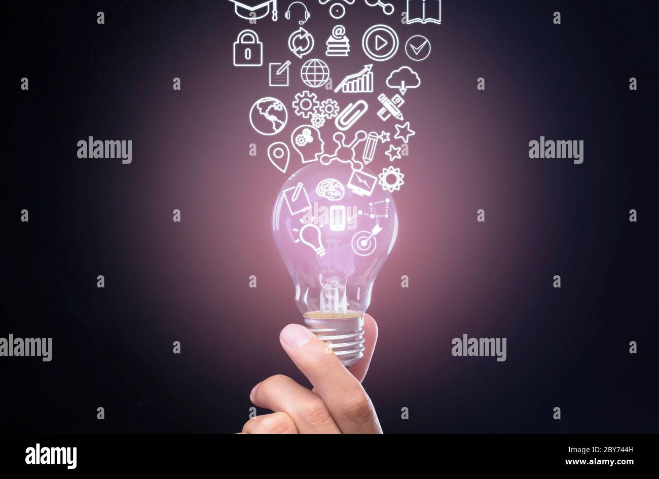 Qualification concept. Hand holds bulb, symbols knowledge, graphics and settings flow up from it Stock Photo