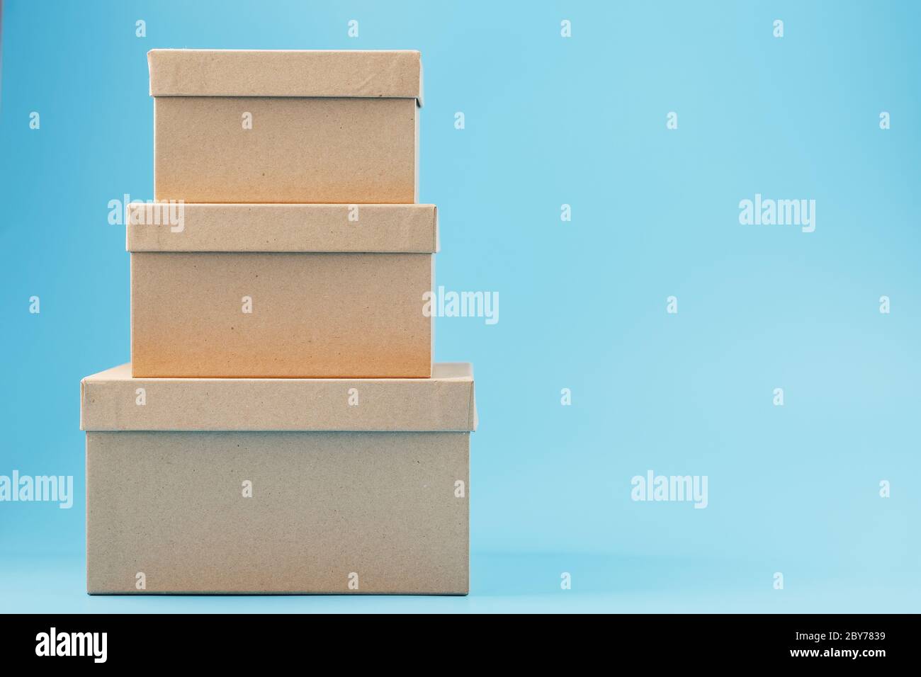 Cardboard boxes on a blue background, free space. isolate Stock Photo