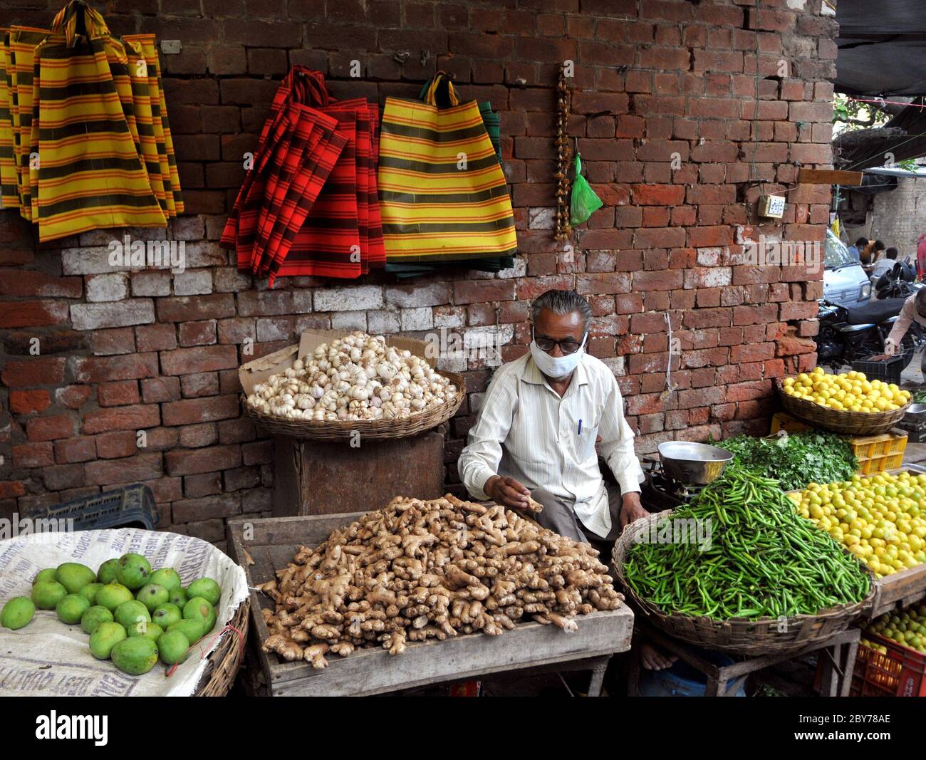 Vegetable vendor waits customers in hires stock photography and images
