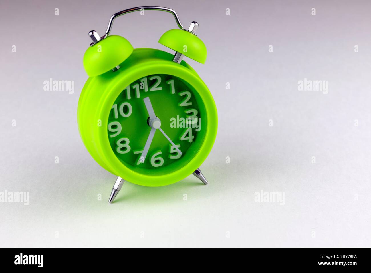 Green Alarm clock isolated on white background Stock Photo - Alamy