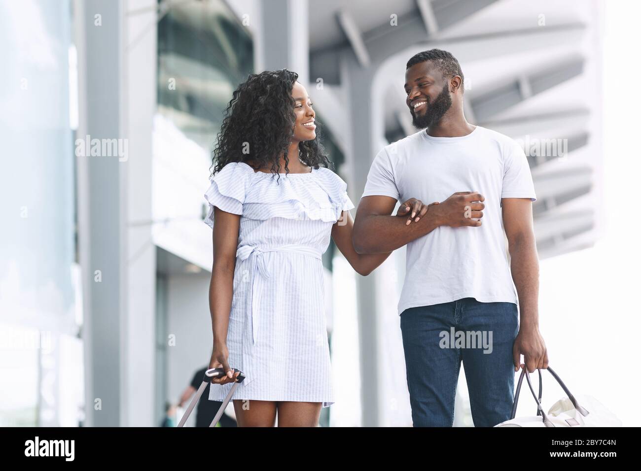 Romantic Travel. Happy Black Couple Walking Near Airport Building With ...