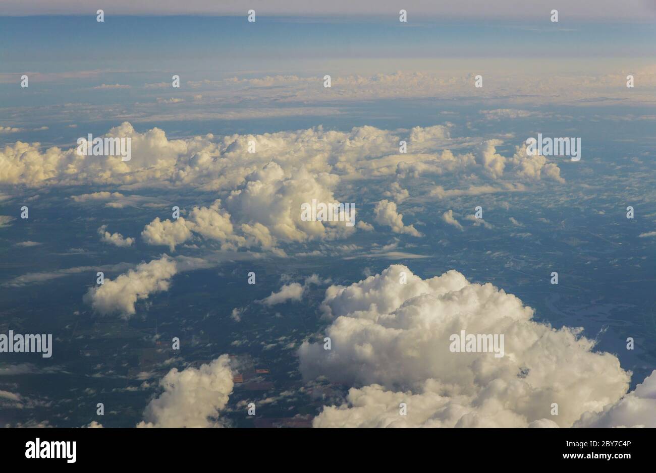 Cloud top aerial view of blue sky beautiful natural landscape from airplane window. Stock Photo