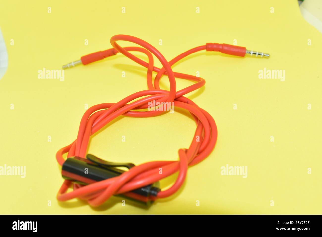 Red color cable in yellow background Stock Photo - Alamy
