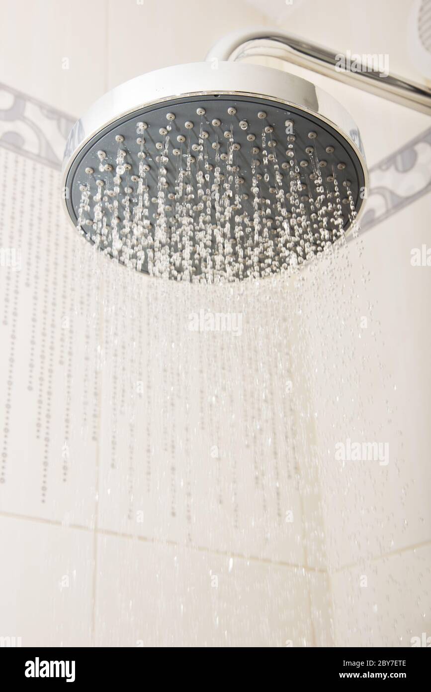 shower head with drops and streams of water Stock Photo Alamy