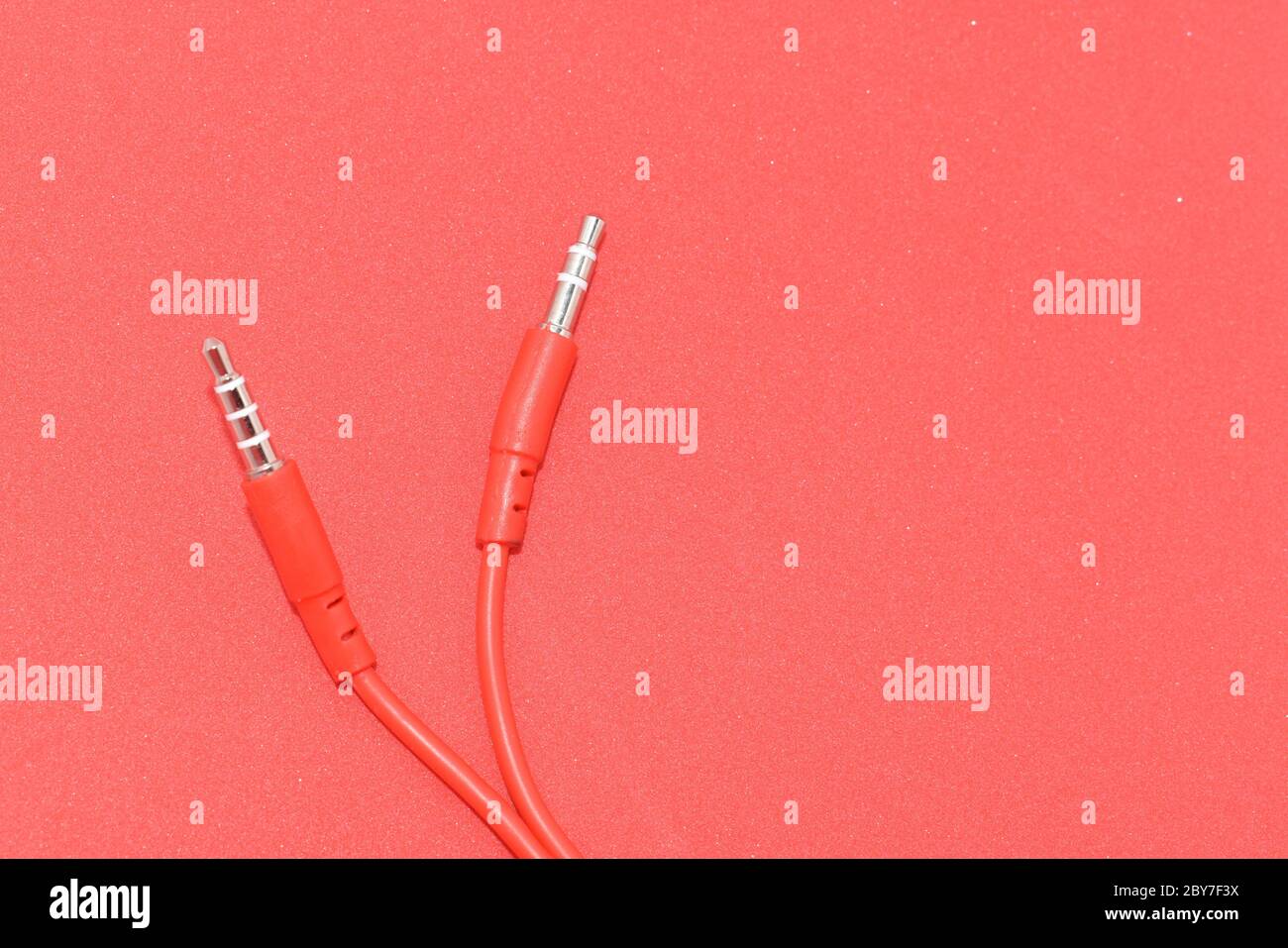 Red color cable isolated in red background Stock Photo - Alamy