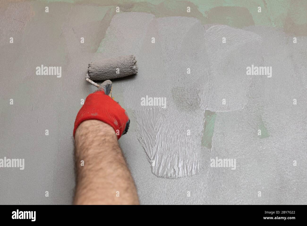 Closeup of an experienced construction worker applying damp insulation