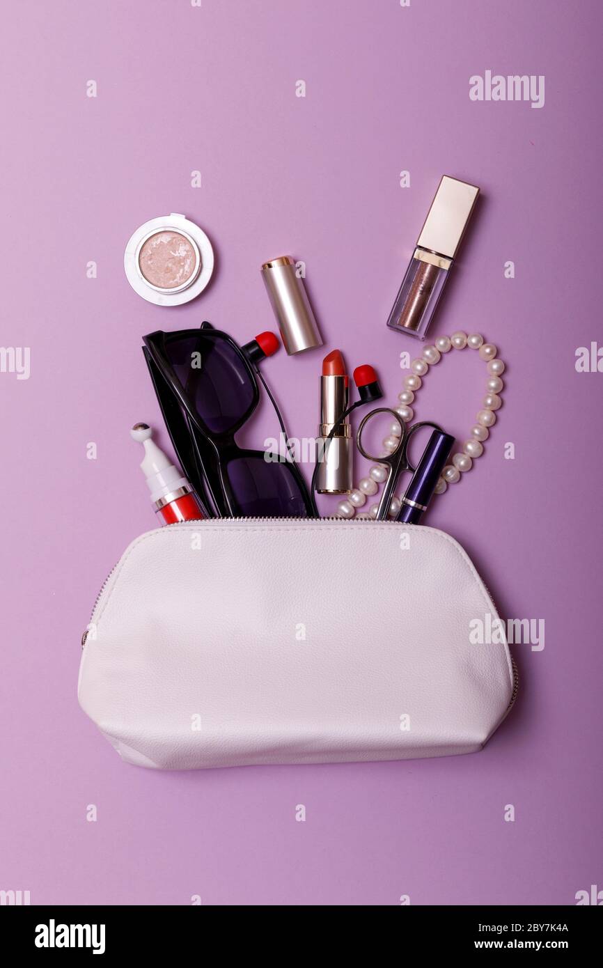 Make up bag with cosmetics isolated on pink background Stock Photo