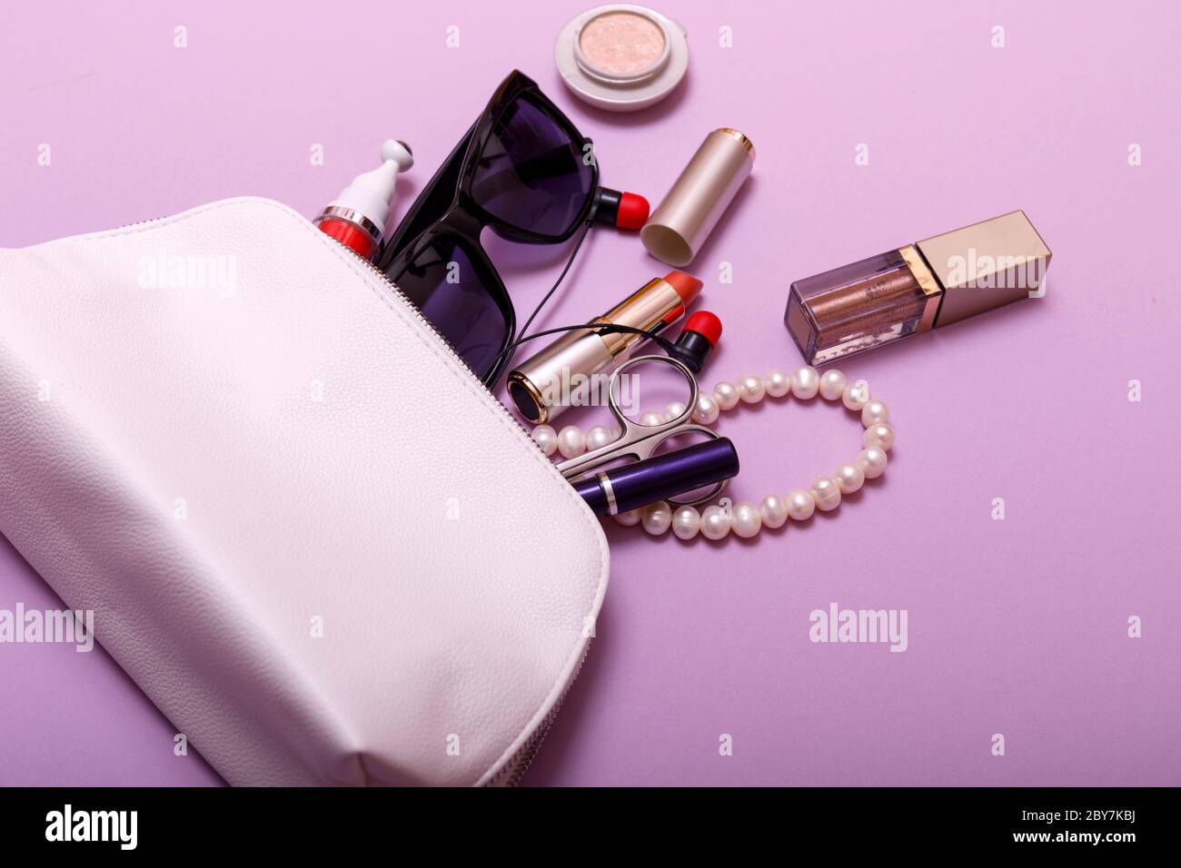 Make up bag with cosmetics isolated on pink background Stock Photo