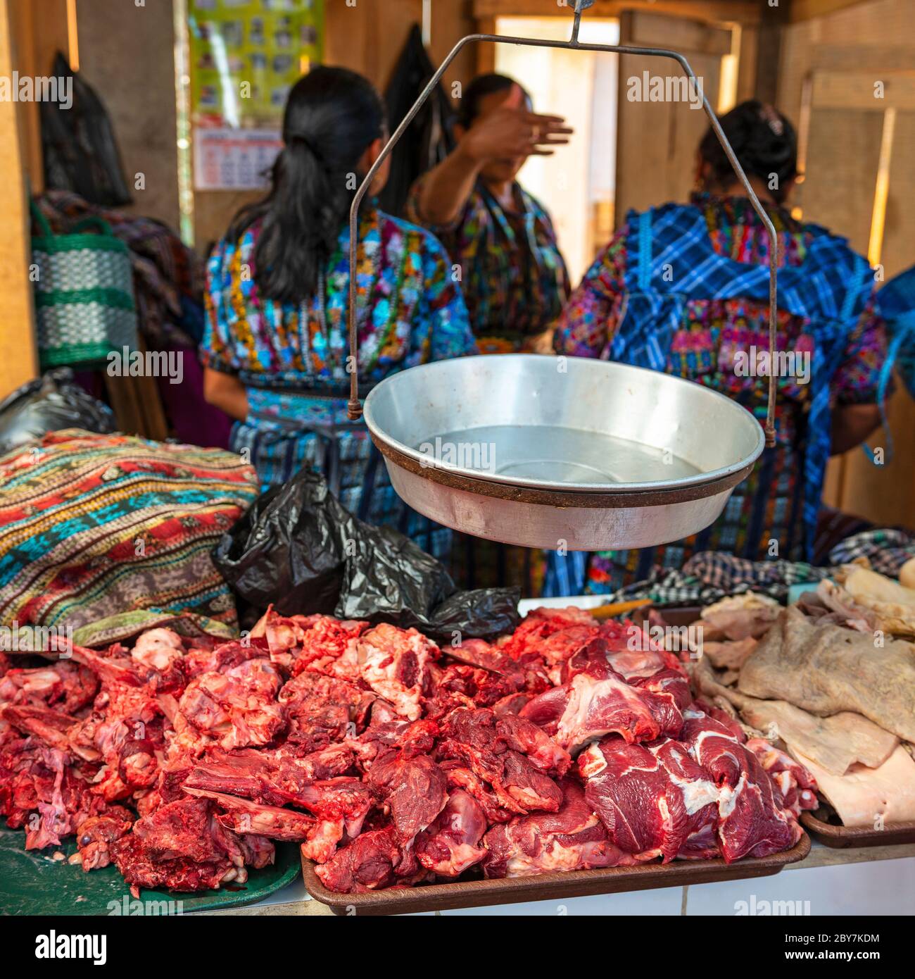 Indigenous Guatemalan Mayan women in traditional clothing on the local market selling beaf and cow stomach, Solola, Guatemala. Stock Photo