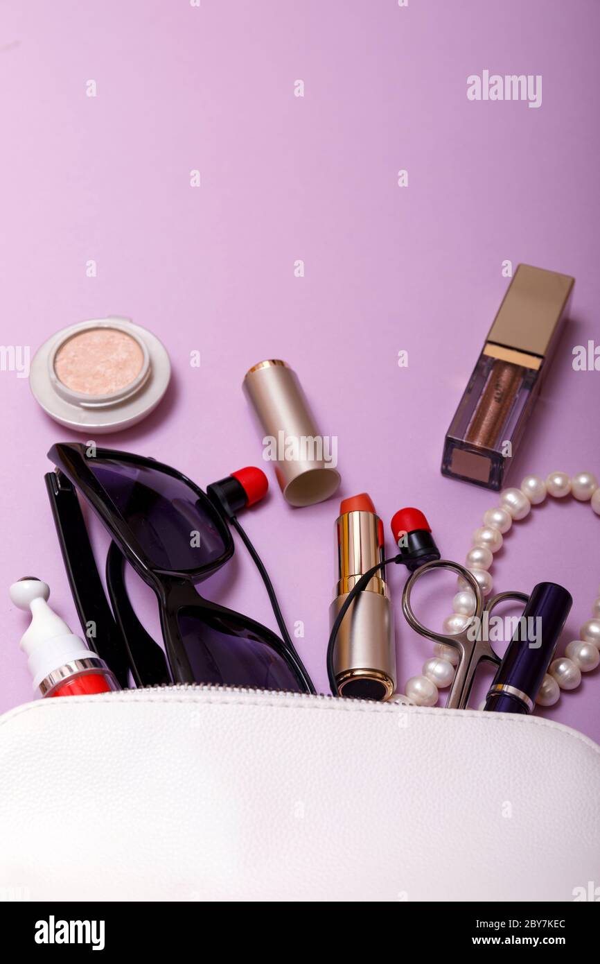 Make up bag with cosmetics isolated on pink background Stock Photo