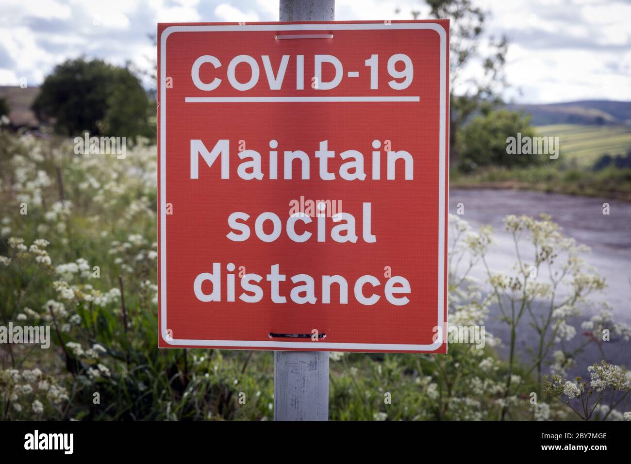 A sign in the countryside near Haworth, West Yorkshire, advising the public to maintain social distancing during the coronavirus pandemic Stock Photo