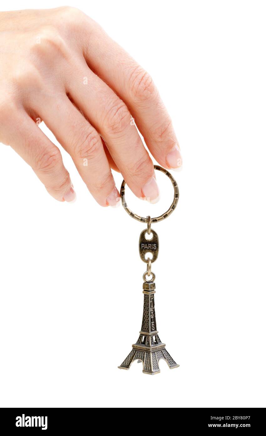Hand holding small Eiffel Tower statuette Stock Photo