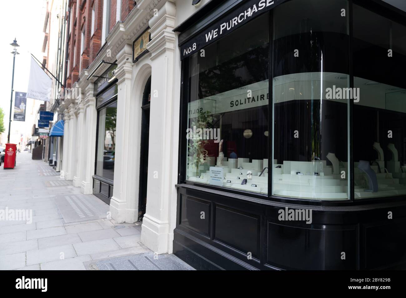 Empty street with closed shops and empty storefront in jewellery