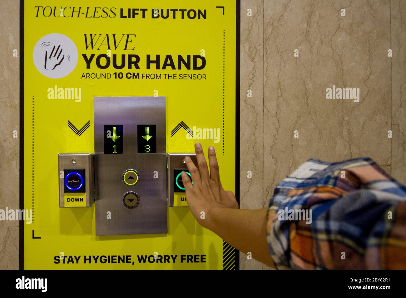 Jakarta, DKI Jakarta, Indonesia. 9th June, 2020. Senayan City Mall visitors scan hand to access the elevator. The mall modified the lift the scan engine to avoid the