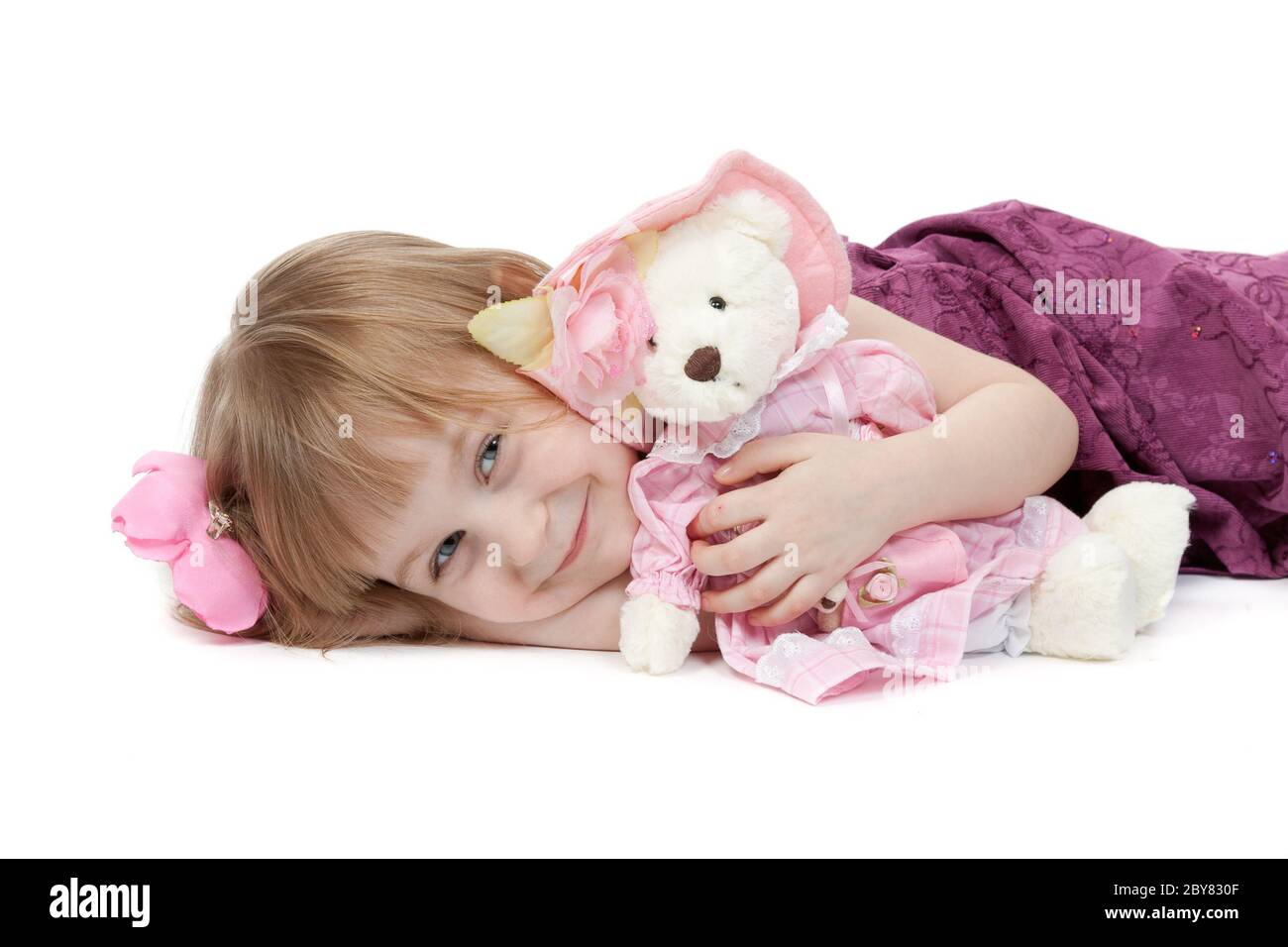 a little girl 4 years old with a plush toy bear Stock Photo