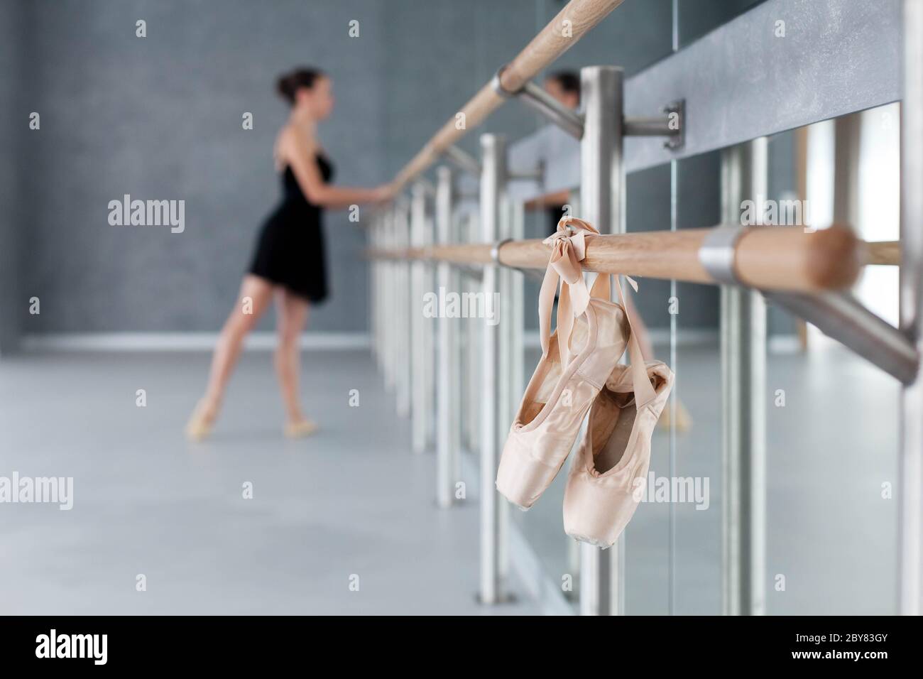 Blurred Background With Ballerina Doing Exercises Pointe Shoes Hang On Ballet Barre Girl Has Dance Workout Stock Photo Alamy