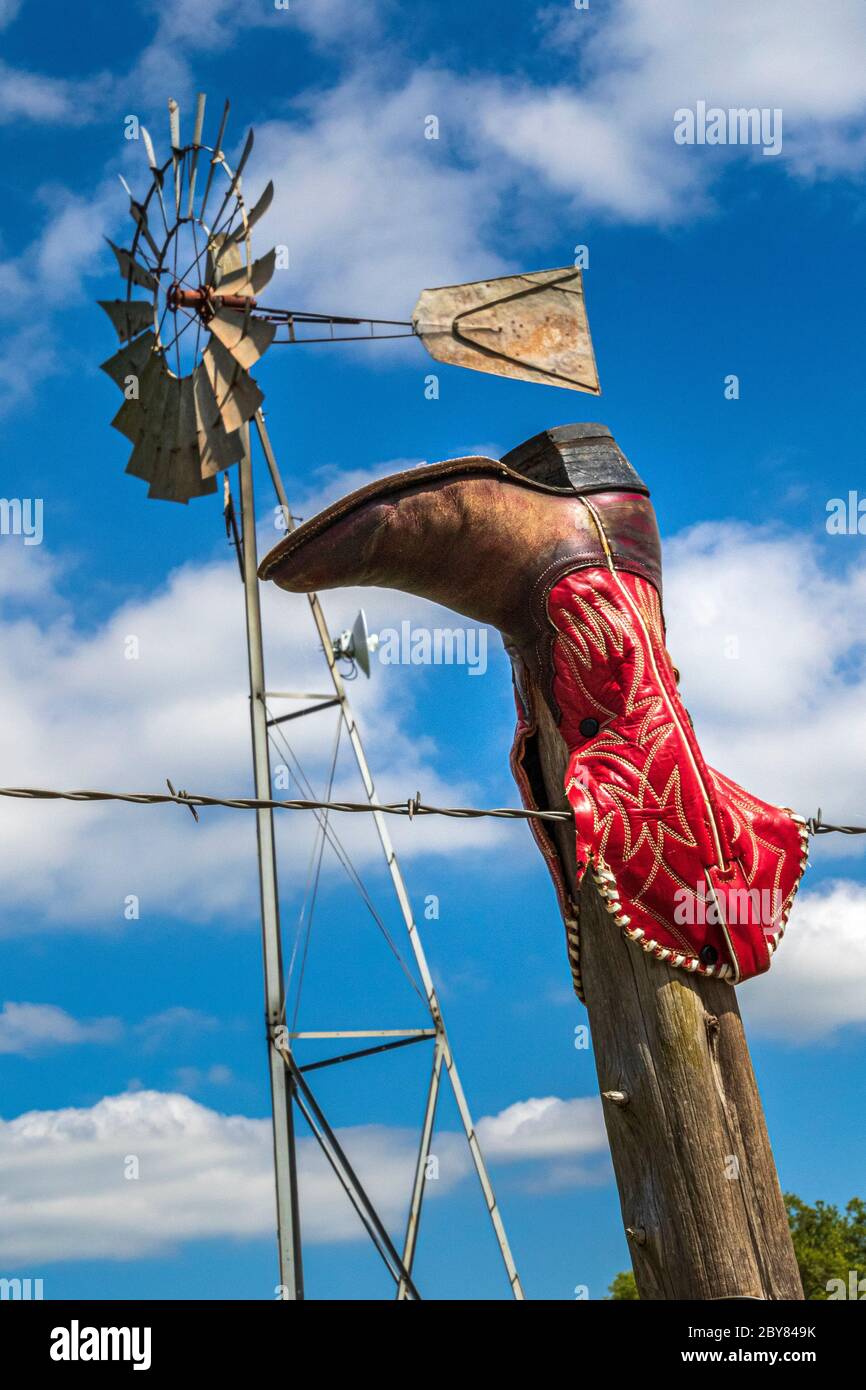 Fredericksburg, Hill Country,Texas,USA,Willow City Loop,cowboy boots,fence,springtime,wildflowers,windmill Stock Photo