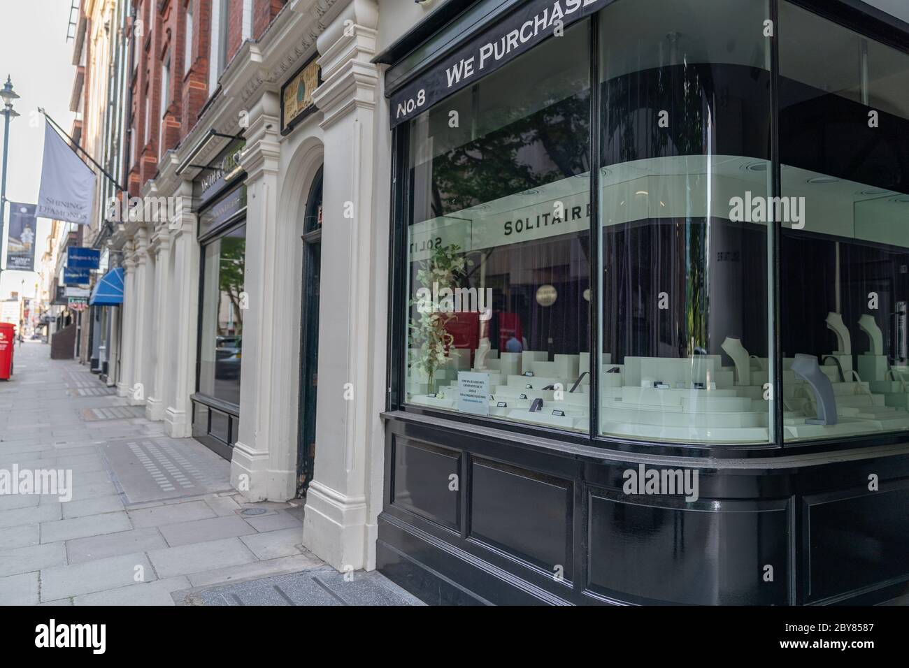 Empty street with closed shops and empty storefront in jewellery