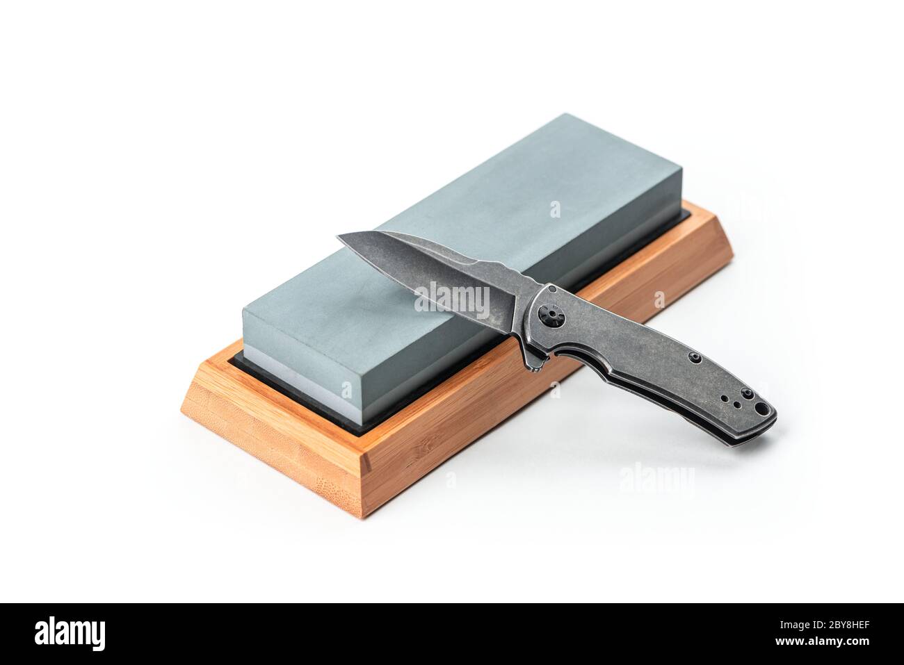 Black pocket knife and a whetstone isolated on white Stock Photo Alamy