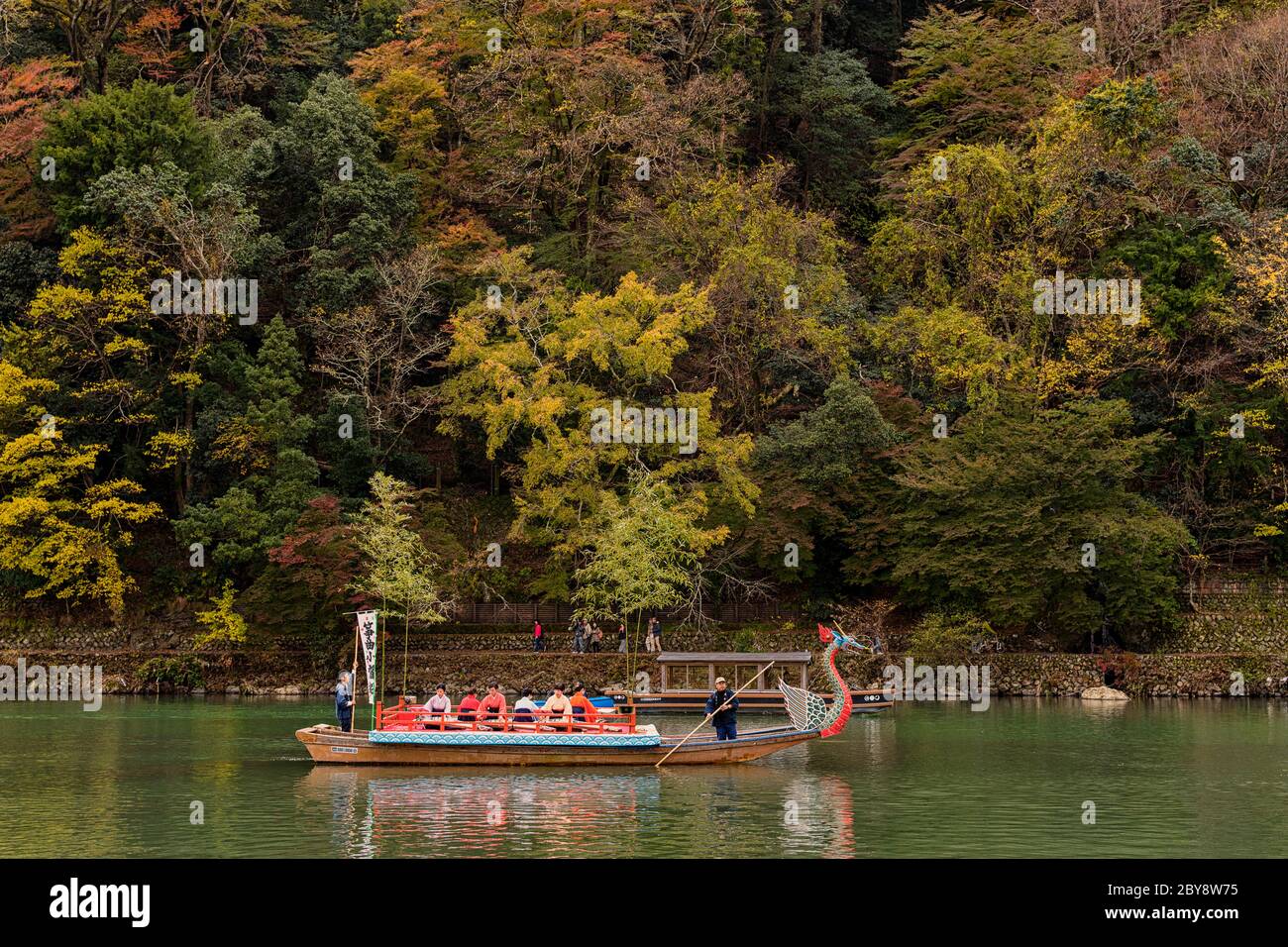 Kyoto / Japan - November 12, 2017: People enjoying traditional boat ride down the Katsura River near Arashiyama park in Kyoto, Japan Stock Photo