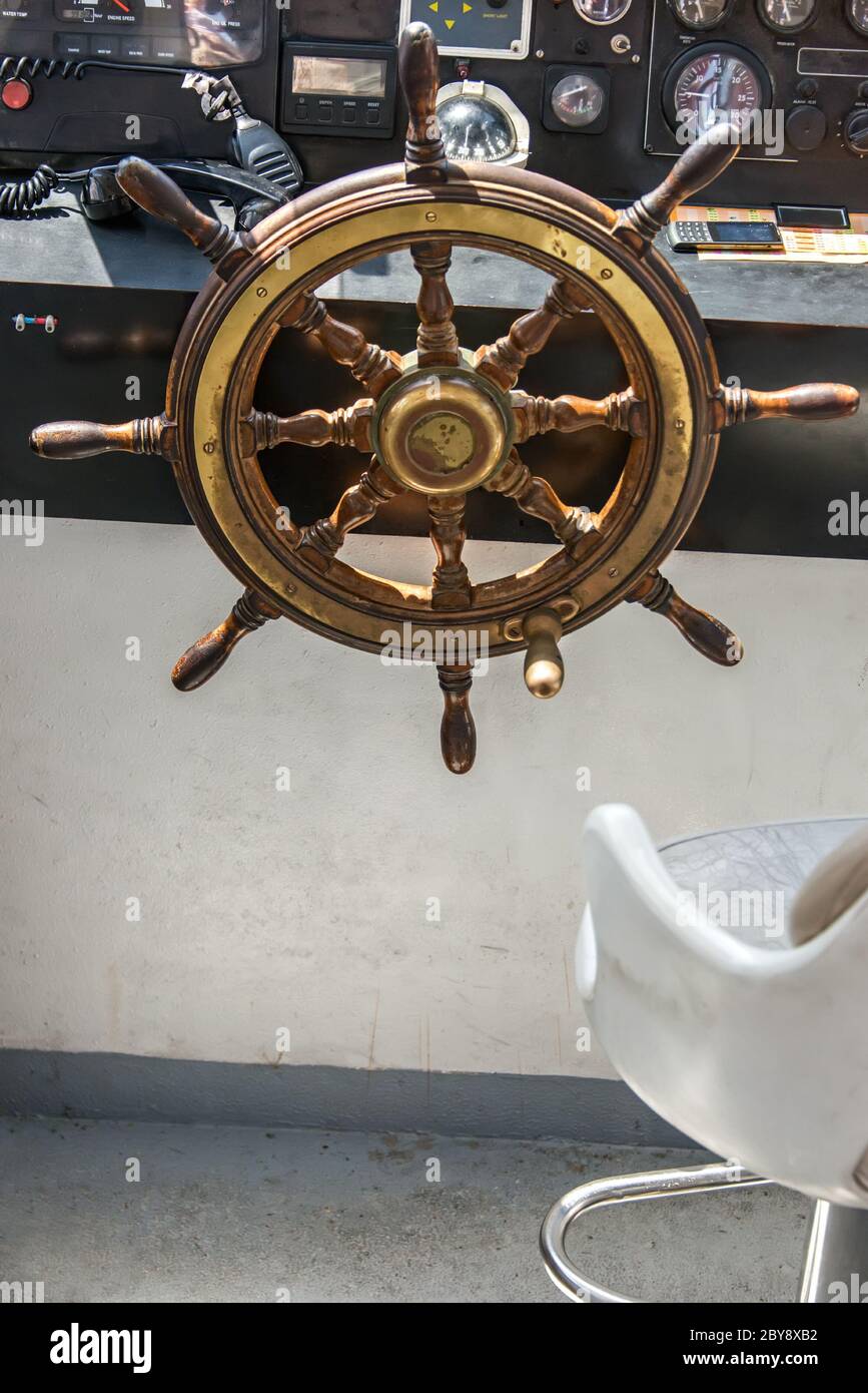 Steering wheel on boat vertical Stock Photo Alamy