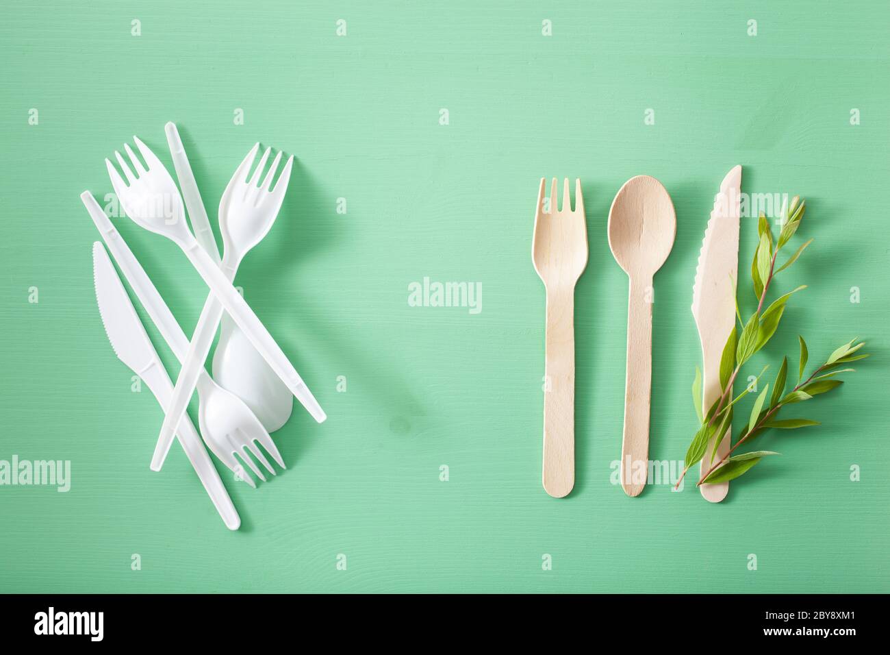 harmful plastic and eco friendly wooden cutlery. plastic free concept