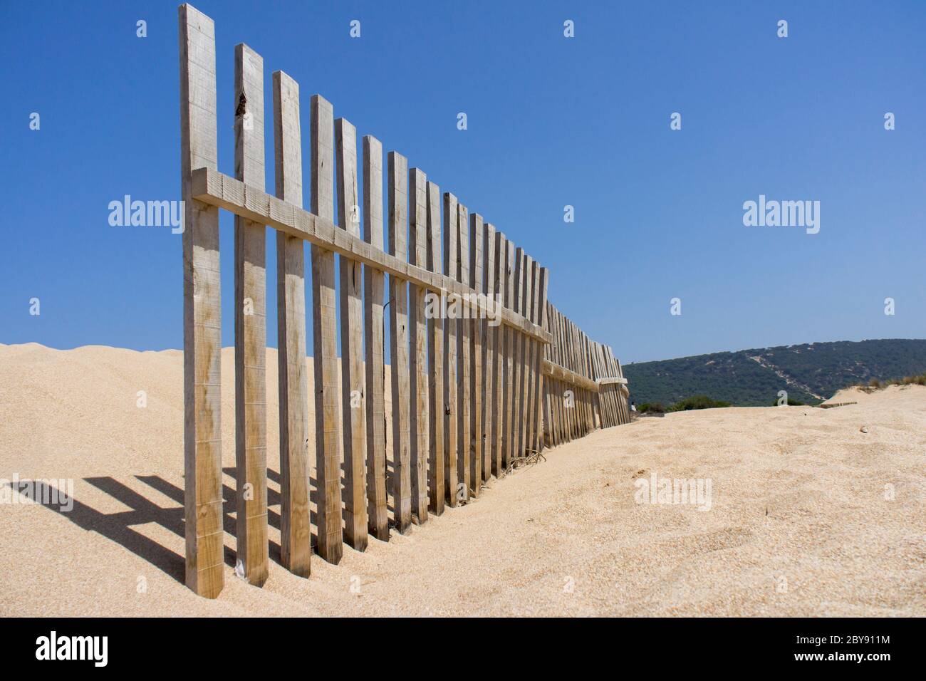wooden fence to hold sand dunes in Cadiz. Andalusia, Spain Stock Photo