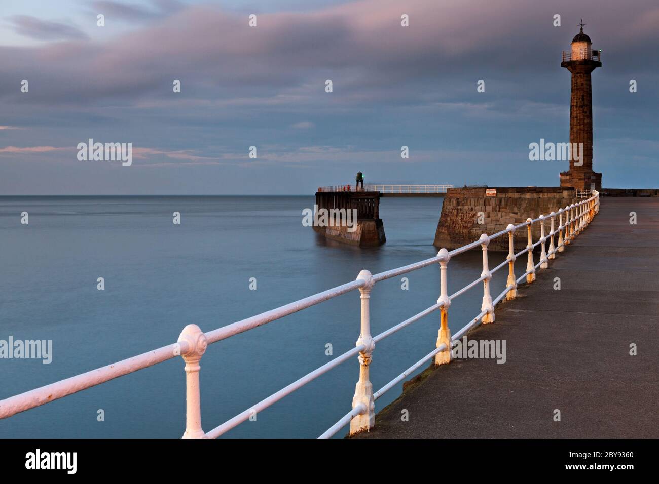 Pier and Lighthouse, Dusk, Whitby, England Stock Photo