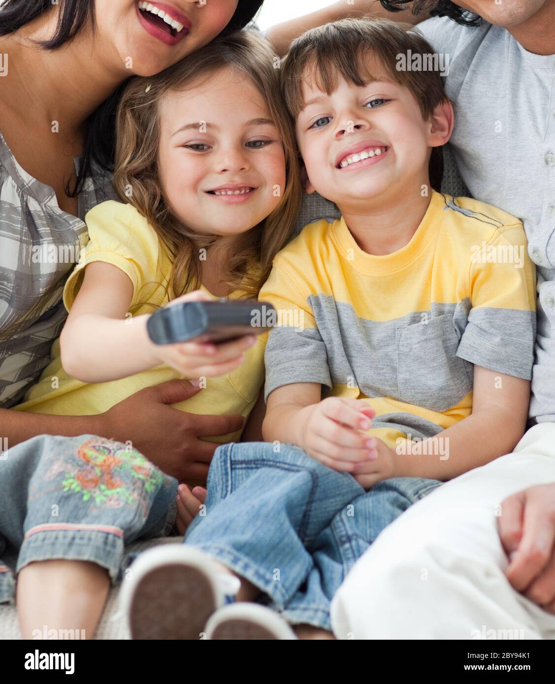 Adorable children watching TV with their parents Stock Photo