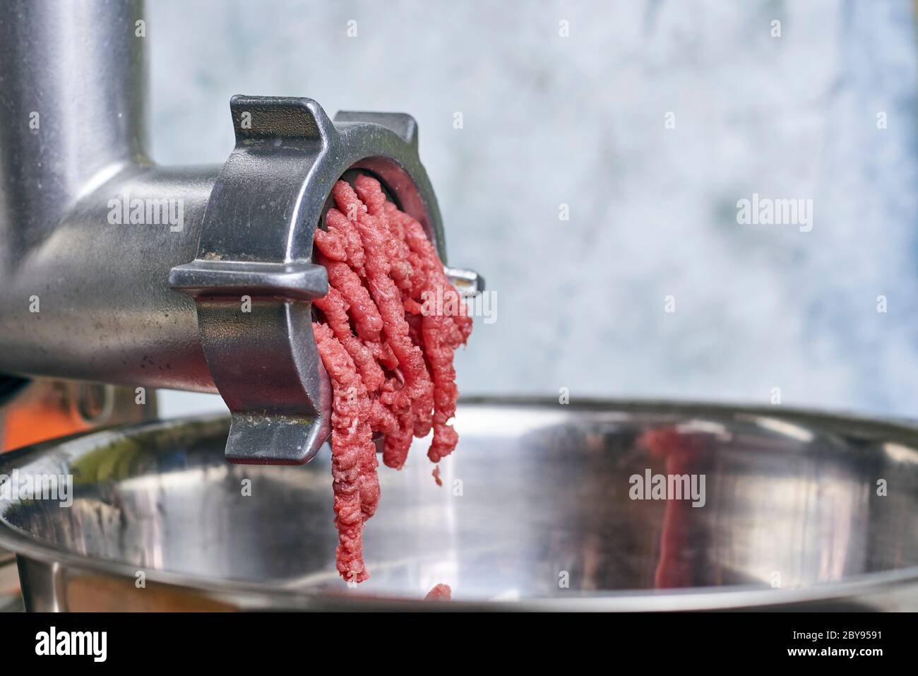 Meat grinder. Kitchen tool to mince meat Stock Photo - Alamy