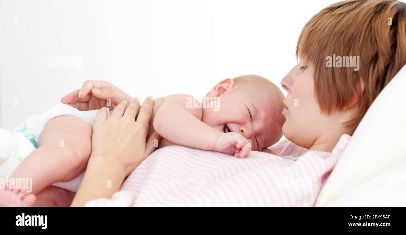 Happy Mother Kissing Her Newborn Baby Stock Photo Alamy