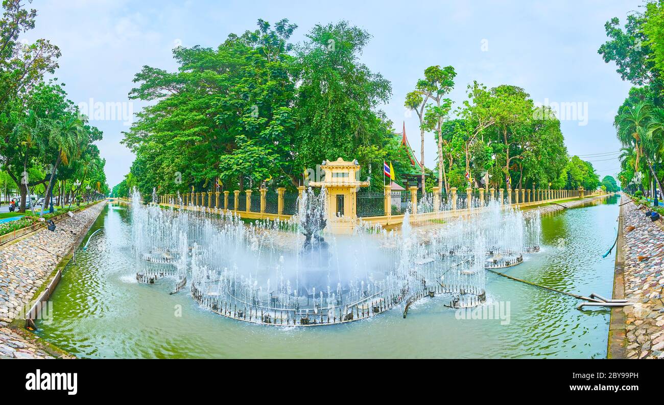 Panorama of the scenic fountains with statue amid the water jets, located in moat of Chitralada Royal Villa, Dusit Palace, Bangkok, Thailand Stock Photo