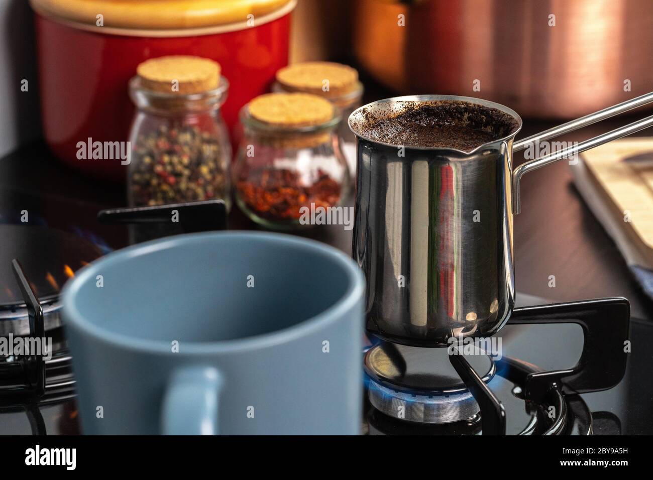 Brew coffee in a steel turk on a gas stove Stock Photo Alamy