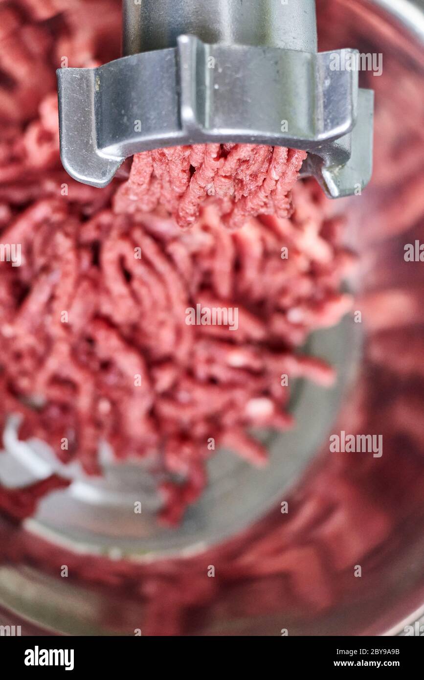 https://c8.alamy.com/comp/2BY9A9B/electric-meat-grinder-kitchen-tool-to-mince-meat-meat-grinding-preparing-food-ingredients-vegan-worst-nightmare-2BY9A9B.jpg