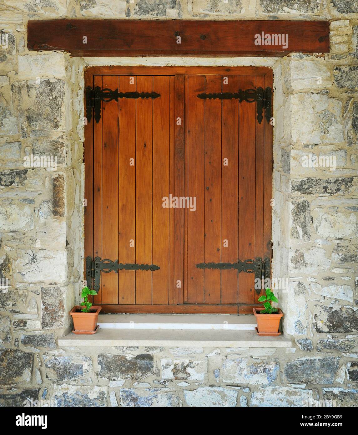 Wooden window in the stone wall Stock Photo - Alamy