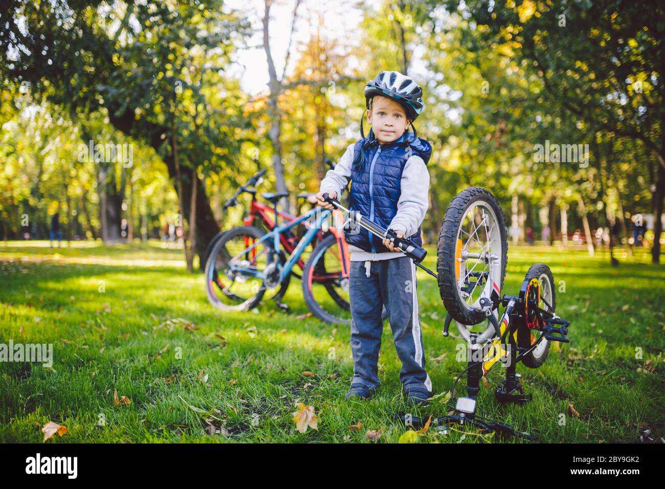 Cyclist boy Bike repair. little boy fixing his bike. Children mechanics