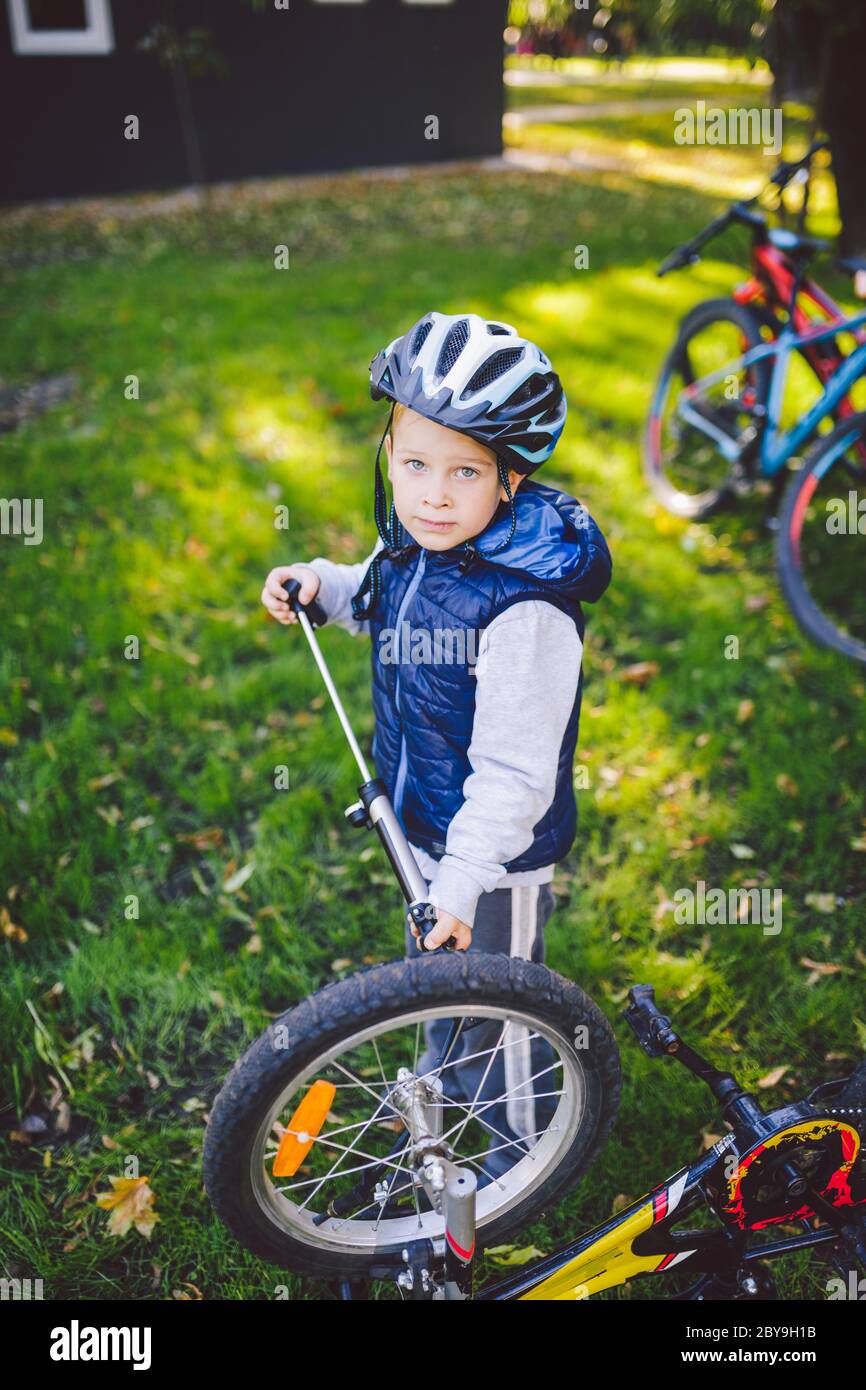 Cyclist boy Bike repair. little boy fixing his bike. Children mechanics
