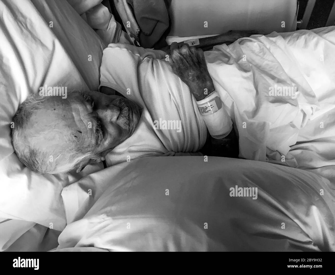 A 92 years old man lays in a geriatric hospital bed, Lyon, France Stock Photo