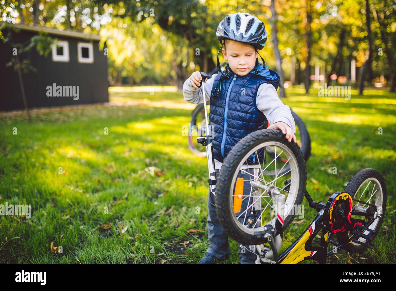 Cyclist boy Bike repair. little boy fixing his bike. Children mechanics