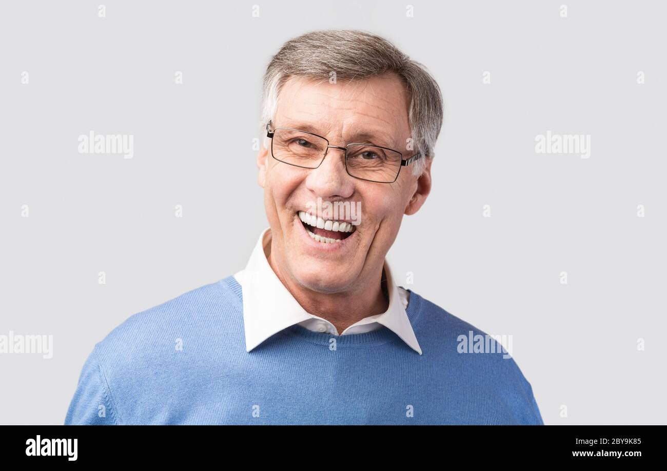 Happy Senior Man Laughing Looking At Camera On Gray Background Stock