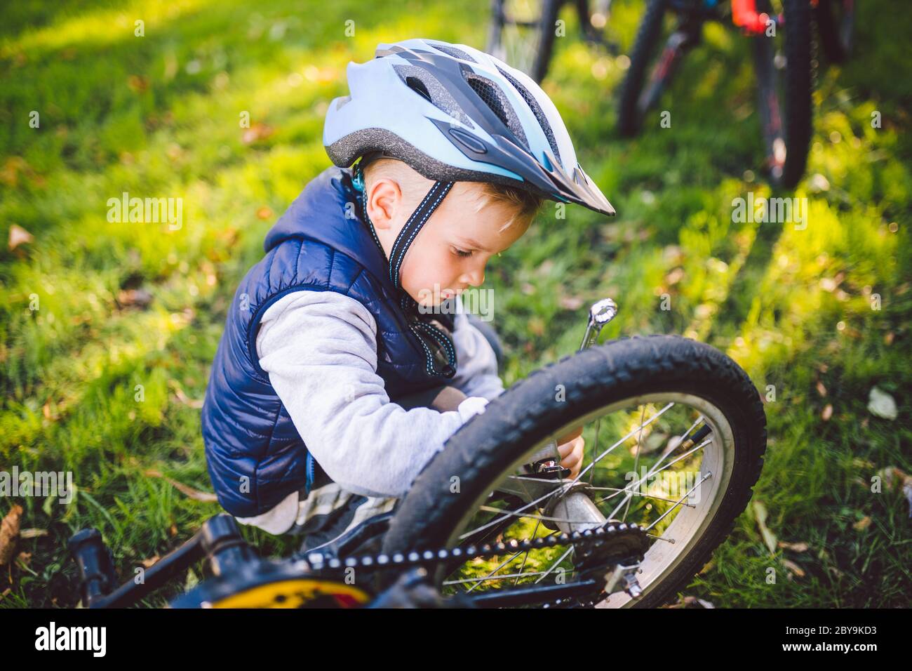 Cyclist boy Bike repair. little boy fixing his bike. Children mechanics