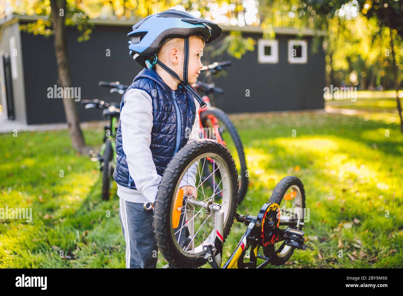Cyclist boy Bike repair. little boy fixing his bike. Children mechanics